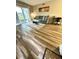 Comfortable living room with wood floors and sliding glass doors at 1000 Lake Of The Woods Blvd # 104F, Casselberry, FL 32730
