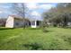 Spacious backyard with a lush lawn and mature trees at 10477 Montpelier Cir, Orlando, FL 32821