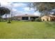 Well-maintained backyard featuring a lush green lawn and mature trees at 10477 Montpelier Cir, Orlando, FL 32821