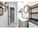 Modern bathroom featuring tile flooring, floating shelves, and a green vanity at 10477 Montpelier Cir, Orlando, FL 32821