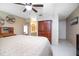 Neutral bedroom featuring wood furniture, a ceiling fan and an ensuite bathroom at 10477 Montpelier Cir, Orlando, FL 32821