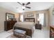 Comfortable bedroom with a ceiling fan, dark wood furniture and an inviting interior design at 10477 Montpelier Cir, Orlando, FL 32821