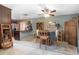Charming dining area featuring wooden table set, pendant lighting, and open flow into living room and kitchen at 10477 Montpelier Cir, Orlando, FL 32821
