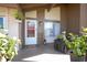Well-decorated front porch with seating, potted plants, and a decorative ladder near the front door at 10477 Montpelier Cir, Orlando, FL 32821
