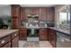 Functional kitchen with updated appliances, dark wood cabinetry, stylish backsplash, and a view of the sink area at 10477 Montpelier Cir, Orlando, FL 32821