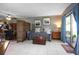 Comfortable living area featuring a sofa, decorative artwork, and a sliding glass door with natural light at 10477 Montpelier Cir, Orlando, FL 32821