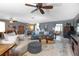 Bright and airy living room with neutral tones, comfortable seating, ceiling fans, and a view of the dining area at 10477 Montpelier Cir, Orlando, FL 32821