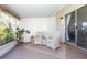 Inviting sunroom with comfortable wicker chairs and views of the outdoors at 10477 Montpelier Cir, Orlando, FL 32821