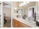 Bathroom with double sink vanity, neutral color palette and framed mirror at 1051 Dunbar Ave, Sanford, FL 32771