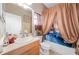 Bathroom with a shower-tub combo, decorative accents and neutral color palette at 1051 Dunbar Ave, Sanford, FL 32771