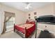 Bedroom with a treadmill, comfortable bed, and natural light from the window at 1051 Dunbar Ave, Sanford, FL 32771