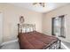 Cozy bedroom features a wrought iron bed frame, fan and natural light at 1051 Dunbar Ave, Sanford, FL 32771