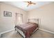 Cozy bedroom with a metal frame bed, neutral walls, and a ceiling fan at 1051 Dunbar Ave, Sanford, FL 32771