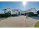 Beautiful single-story home showcasing a manicured lawn, long driveway, and attached two-car garage at 1051 Dunbar Ave, Sanford, FL 32771