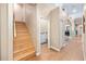 Hallway featuring wooden stairs leading to the upper level and laundry room entrance at 1051 Dunbar Ave, Sanford, FL 32771