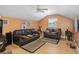 Cozy living room featuring light wood floors, a ceiling fan, and comfortable seating at 1051 Dunbar Ave, Sanford, FL 32771