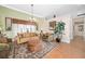 Inviting living room featuring tile floors, a large decorative rug, and ample seating at 1051 Dunbar Ave, Sanford, FL 32771