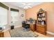 Bright home office with a ceiling fan, wooden desk and drawers, neutral walls, and a patterned rug at 1051 Dunbar Ave, Sanford, FL 32771
