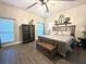 Spacious bedroom with a large window, dark wood floors, and ceiling fan at 1226 Deer Lake Cir, Apopka, FL 32712