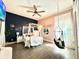 Colorful bedroom with bed, ceiling fan, light wood floors, and natural light at 1226 Deer Lake Cir, Apopka, FL 32712