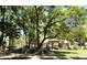 Inviting home surrounded by mature trees and lush landscaping offering shaded curb appeal at 1226 Deer Lake Cir, Apopka, FL 32712