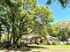 Attractive house surrounded by mature landscaping and trees providing shade and privacy at 1226 Deer Lake Cir, Apopka, FL 32712