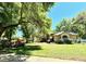 Beautiful home with mature trees and vibrant landscaping offering shaded curb appeal at 1226 Deer Lake Cir, Apopka, FL 32712