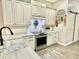 Bright kitchen featuring quartz countertops, stainless steel appliances, and white cabinetry at 1226 Deer Lake Cir, Apopka, FL 32712