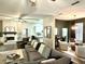 Spacious living area features a fireplace, comfortable seating, and an open layout leading to the dining area at 1226 Deer Lake Cir, Apopka, FL 32712