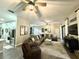 Spacious living room featuring neutral tones, an area rug and sleek ceiling fan at 1226 Deer Lake Cir, Apopka, FL 32712