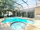 Sparkling pool and spa area surrounded by a screened enclosure and a spacious patio for entertaining at 1226 Deer Lake Cir, Apopka, FL 32712