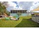 Outdoor space featuring a fire pit, and screened-in porch at 1258 Russell Dr, Ocoee, FL 34761