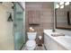 Bathroom showcasing a tiled walk-in shower, single sink vanity, framed mirror, and a toilet at 1258 Russell Dr, Ocoee, FL 34761