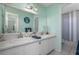 Bathroom features a double sink vanity, large mirror, and a shower and toilet at 1258 Russell Dr, Ocoee, FL 34761