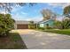 Charming single-story home featuring a two-car garage, and well-maintained landscaping, showcasing curb appeal at 1258 Russell Dr, Ocoee, FL 34761
