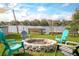 Outdoor fire pit surrounded by Adirondack chairs, with views of the lake at 1258 Russell Dr, Ocoee, FL 34761