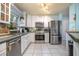 Modern kitchen with stainless steel appliances, white cabinetry, and tiled flooring at 1258 Russell Dr, Ocoee, FL 34761