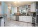 Bright kitchen with white cabinetry, stainless steel appliances, and eat-in bar area at 1258 Russell Dr, Ocoee, FL 34761