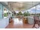 Spacious screened patio with a seating area, a hot tub, and large windows overlooking the backyard at 1258 Russell Dr, Ocoee, FL 34761