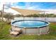 Inviting above-ground pool with a shade and ladder steps offering relaxation and recreation at 1258 Russell Dr, Ocoee, FL 34761
