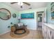 Sitting area with a comfortable chair, round area rug, wall decorations, and natural lighting at 1258 Russell Dr, Ocoee, FL 34761