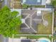 An aerial view of the home reveals the backyard landscaping, gray roof and perimeter fencing at 1259 Vanderbilt Dr, Ormond Beach, FL 32174