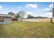 Open backyard featuring a walkway, privacy fence and lush green grass at 1259 Vanderbilt Dr, Ormond Beach, FL 32174