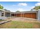 Backyard concrete patio with stained wood privacy fence and white awning at 1259 Vanderbilt Dr, Ormond Beach, FL 32174