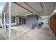 Backyard patio with gray painted exterior, a white awning and an access gate at 1259 Vanderbilt Dr, Ormond Beach, FL 32174