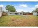 Spacious backyard with lush greenery, a privacy fence, and covered parking at 1259 Vanderbilt Dr, Ormond Beach, FL 32174