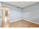 An empty bedroom with neutral walls, tile flooring, and access to an adjacent hallway at 1259 Vanderbilt Dr, Ormond Beach, FL 32174