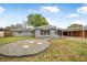 Single-story home featuring a gravel area and covered parking on a grassy lot at 1259 Vanderbilt Dr, Ormond Beach, FL 32174