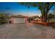Charming single Gathering home with a two-car garage, and mature tree with deck at dusk at 1259 Vanderbilt Dr, Ormond Beach, FL 32174