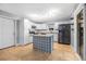 Well-lit kitchen featuring white cabinets, modern appliances, and a center island at 1259 Vanderbilt Dr, Ormond Beach, FL 32174